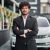Indian businessman in the background of his car.